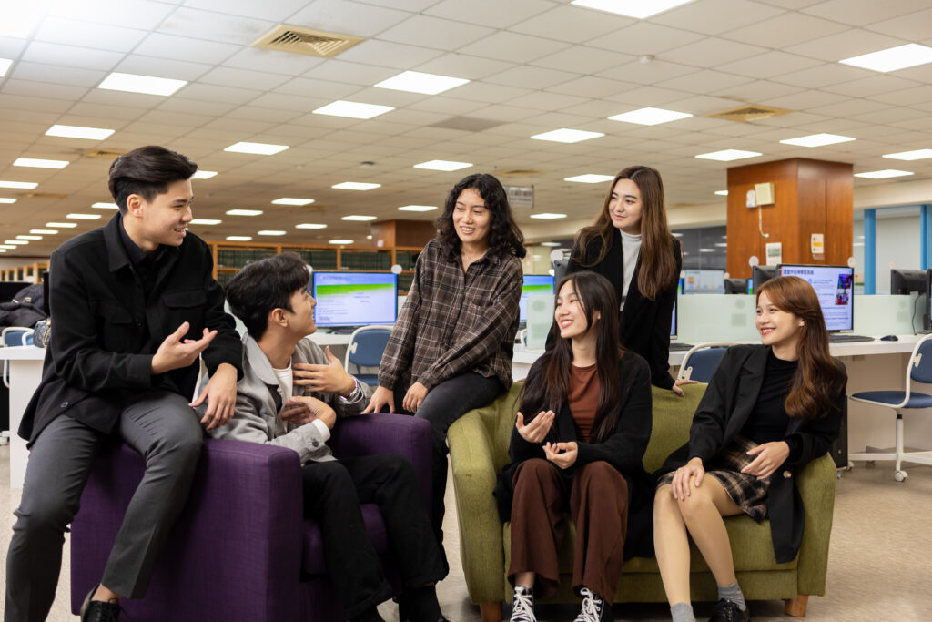 Diverse group of international students chatting in the library during their study in Taiwan at I-Shou University